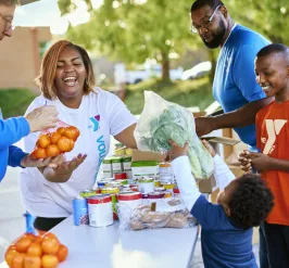 Y staff and volunteers giving out food to the community. 