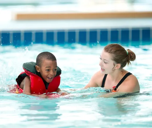 swim instructor and student in pool